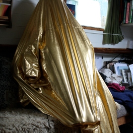 Day 18. Me making shapes inside gold stretchy fabric.